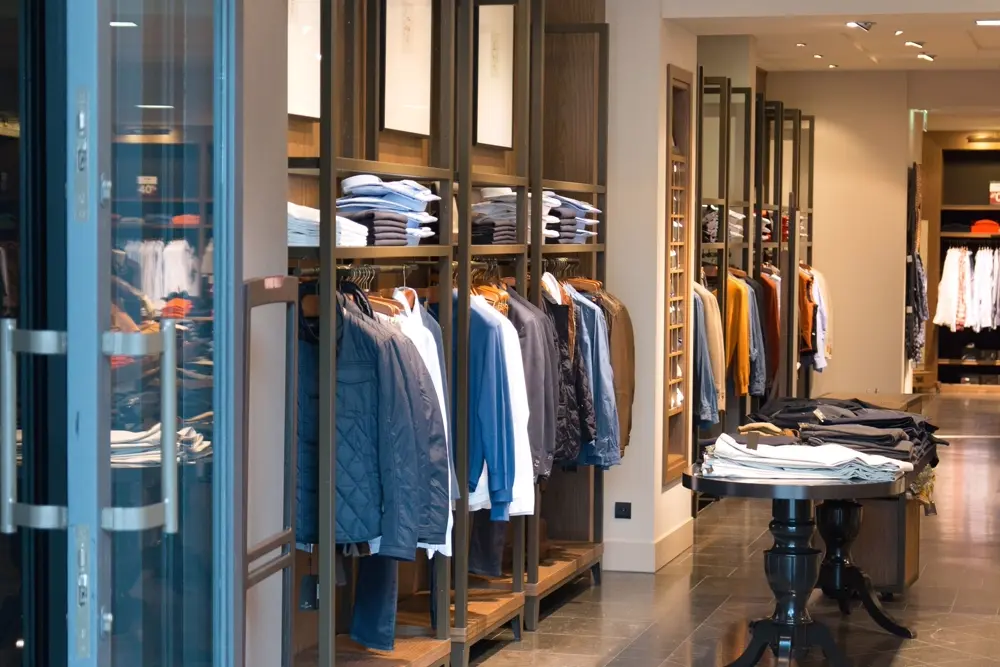 Perchero con prendas de ropa colgadas en una boutique bien iluminada, referencia al contenido de moda en Instagram Mexico
